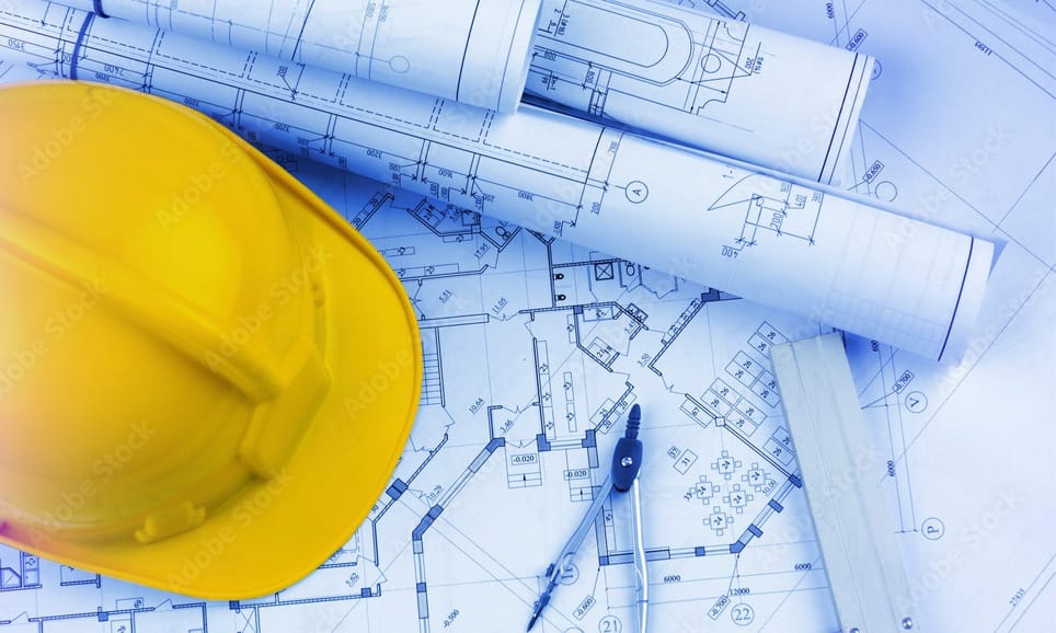 Construction blueprint with yellow hard hat